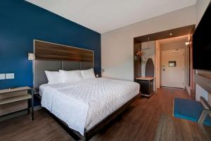 a bedroom with a large bed and a blue wall at Tru By Hilton Mooresville in Mooresville +33 photos
