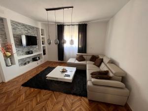 a living room with a couch and a table at Apartman Žanić Ogulin in Ogulin