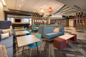 a lobby with tables and couches in a hospital at Tru By Hilton Rock Hill, SC in Rock Hill
