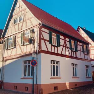 a half timbered house with a red roof at Pures Glück Seligenstadt in Seligenstadt