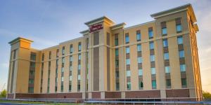 a large building with a sign on top of it at Hampton Inn & Suites Charlotte/Ballantyne, Nc in Charlotte