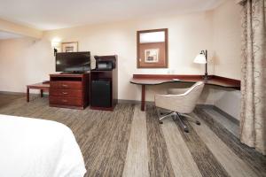 a hotel room with a desk and a computer at Hampton Inn & Suites Greensburg in Greensburg