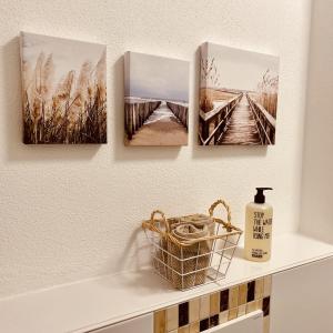 a shelf with four pictures on a wall at Neues Glück Seligenstadt in Seligenstadt