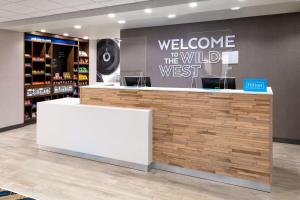 a welcome to the wild west counter in a store at Hampton Inn & Suites Cody, Wy in Cody