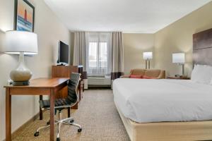 a hotel room with a bed and a desk with a computer at Comfort Inn Manistique in Manistique +45 photos