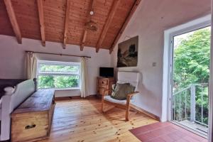 a room with a desk and a chair and a window at Keadue Holiday Cottage in Burtonport