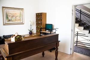 a piano in a living room with a staircase at Hotel Arianna in Iseo