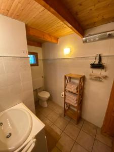 a bathroom with a white toilet and a sink at Casa Cantone Devero-baita storica con balcone e giardino, posizione comoda e soleggiata- spazio biciclette in Alpe Devero