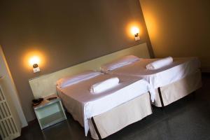 Postel nebo postele na pokoji v ubytování Hotel Arianna