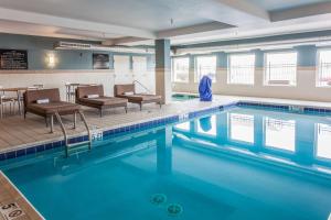 a large swimming pool with chairs and a table at Hampton Inn Colorado Springs-Airport in Colorado Springs
