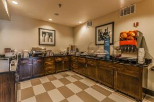 a kitchen with wooden cabinets and oranges on the counter at Hampton Inn Colorado Springs-Airport in Colorado Springs