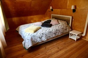 a bedroom with a bed with two pillows on it at Brīvdienu māja Pūces in Līgatne +11 photos