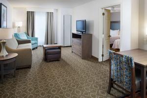 a hotel room with a bed and a living room at Homewood Suites by Hilton Colorado Springs-North in Colorado Springs
