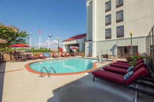 a pool in front of a hotel with a red couch at Hampton Inn Christiansburg/Blacksburg in Christiansburg