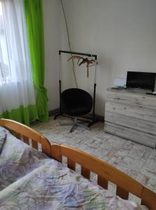 a bedroom with a bed and a chair and a dresser at U lesa in Bohutín