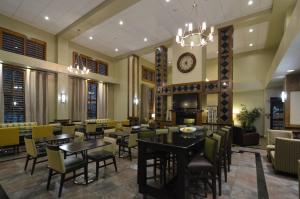 a restaurant with tables and chairs and a clock at Hampton Inn & Suites Carson City in Carson City