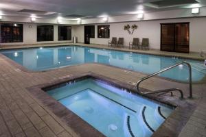 a pool in a hotel room with a large swimming pool at Hampton Inn & Suites Carson City in Carson City