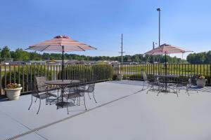 a patio with tables and chairs and umbrellas at Hampton Inn Carbondale in Carbondale