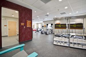 a gym with a rack of towels and machines at Home2 Suites By Hilton Blue Ash Cincinnati in Blue Ash