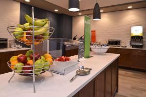 a kitchen with two baskets of fruit on a counter at Hampton Inn & Suites Cincinnati-Mason, Ohio in Mason