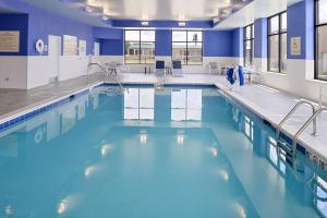 a swimming pool with blue water in a building at Hampton Inn & Suites Cincinnati-Mason, Ohio in Mason