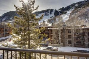 a view from the balcony of a resort with a christmas tree at Hotel Durant in Aspen
