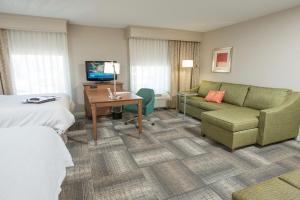 a hotel room with a bed and a couch at Hampton Inn & Suites Cincinnati-Union Centre in West Chester