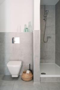 a bathroom with a shower and a toilet and a tub at BRACKEN COTTAGE, The Lanes Cottages, Stokesley in Stokesley