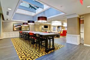 a dining room and kitchen with a table and chairs at Hampton Inn and Suites Cincinnati - Downtown in Cincinnati