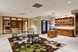 a lobby with a table and chairs in a store at Homewood Suites by Hilton Cincinnati-Downtown in Cincinnati