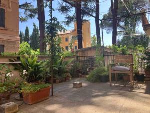 a garden with a chair and plants and a building at Monti Parioli House in Rome