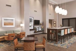 Hampton Inn & Suites - DeLand في دو لاند: غرفة طعام مع طاولة وكراسي