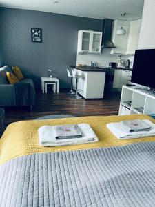 a bedroom with a bed with two towels on it at Compact apartment in Rauma in Rauma