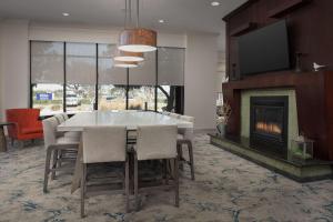 a dining room with a table and a fireplace at Hilton Garden Inn Dallas/Duncanville in Duncanville