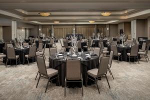 a ballroom with tables and chairs and a room filled with at Hilton Garden Inn Dallas/Duncanville in Duncanville +32 photos