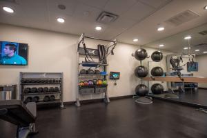 a room with a gym with weights and a tv at Tru By Hilton Allen Dallas, Tx in Allen