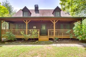 a house with a porch with a green door at Dreamy Dahlonega Cabin with Deck and Fireplace! in Dahlonega