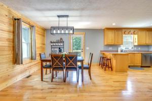 a kitchen and dining room with a table and chairs at Dreamy Dahlonega Cabin with Deck and Fireplace! in Dahlonega