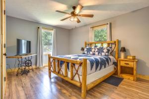 a bedroom with a bed and a ceiling fan at Dreamy Dahlonega Cabin with Deck and Fireplace! in Dahlonega