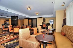 a hotel room with tables and chairs and a living room at Hampton Inn Eden in Eden