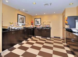 a large kitchen with a checkered floor and cabinets at Hampton Inn Eden in Eden