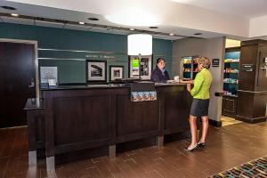 two women standing at a cash register in a store at Hampton Inn by Hilton Dayton South in Miamisburg