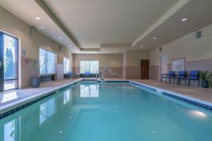 a swimming pool with blue water in a building at Hampton Inn Dahlgren in Dahlgren