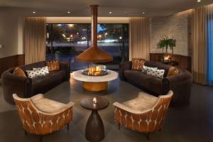 a living room with couches and a table and chairs at Canopy by Hilton Washington DC Embassy Row in Washington