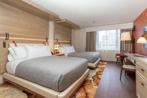 a hotel room with two beds and a desk at Canopy by Hilton Washington DC Embassy Row in Washington