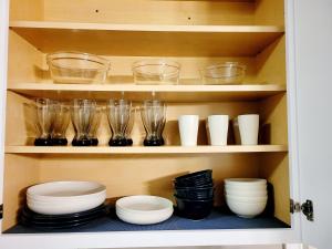 a cabinet filled with bowls and plates and glasses at White Mountain Barn in Littleton