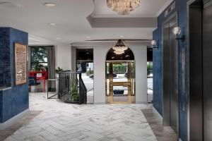 a lobby with a door and a chandelier at West End Washington DC, Tapestry Collection by Hilton in Washington, D.C.