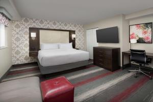 a hotel room with a bed and a television at West End Washington DC, Tapestry Collection by Hilton in Washington