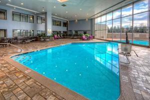 a large pool with blue water in a hotel lobby at DoubleTree by Hilton Decatur Riverfront in Decatur
