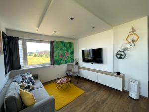 A television and/or entertainment centre at MK Apartment FREE Parking